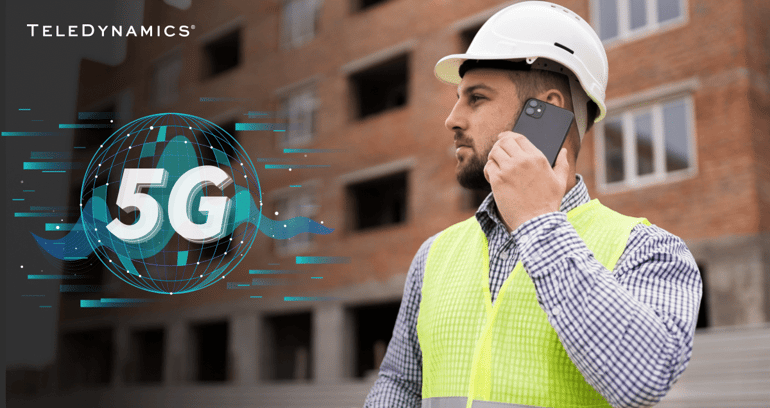field worker with hard hat and yellow reflective vest talking on a mobile phone with 5G - TeleDynamics blog