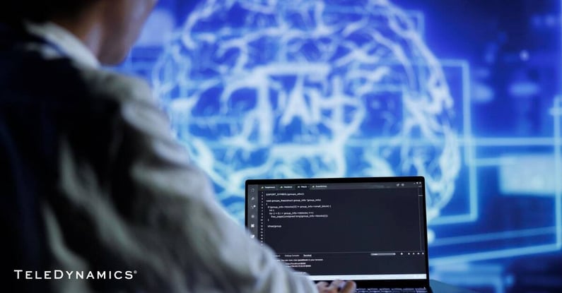network engineer managing an AI-driven network from a laptop - TeleDynamics blog