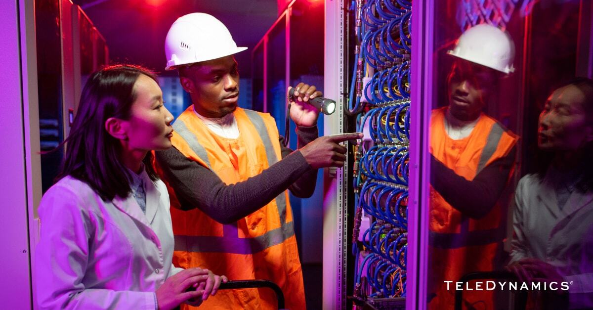 Network engineers working in a server room - TeleDynamics blog