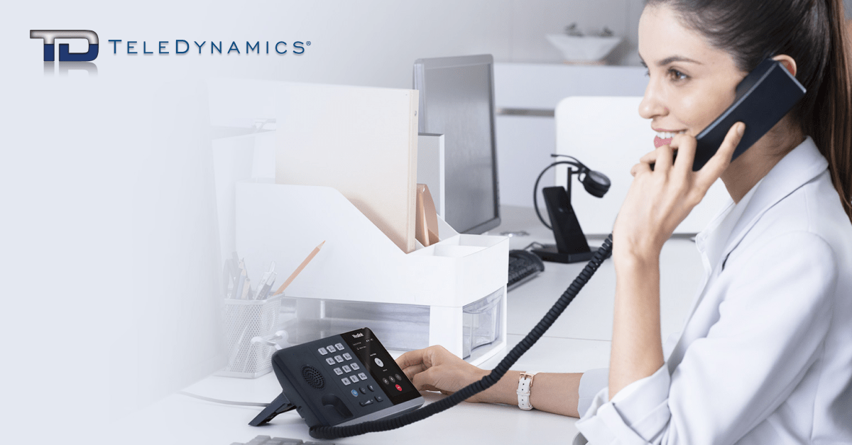 Woman using VoIP service - TeleDynamics blog