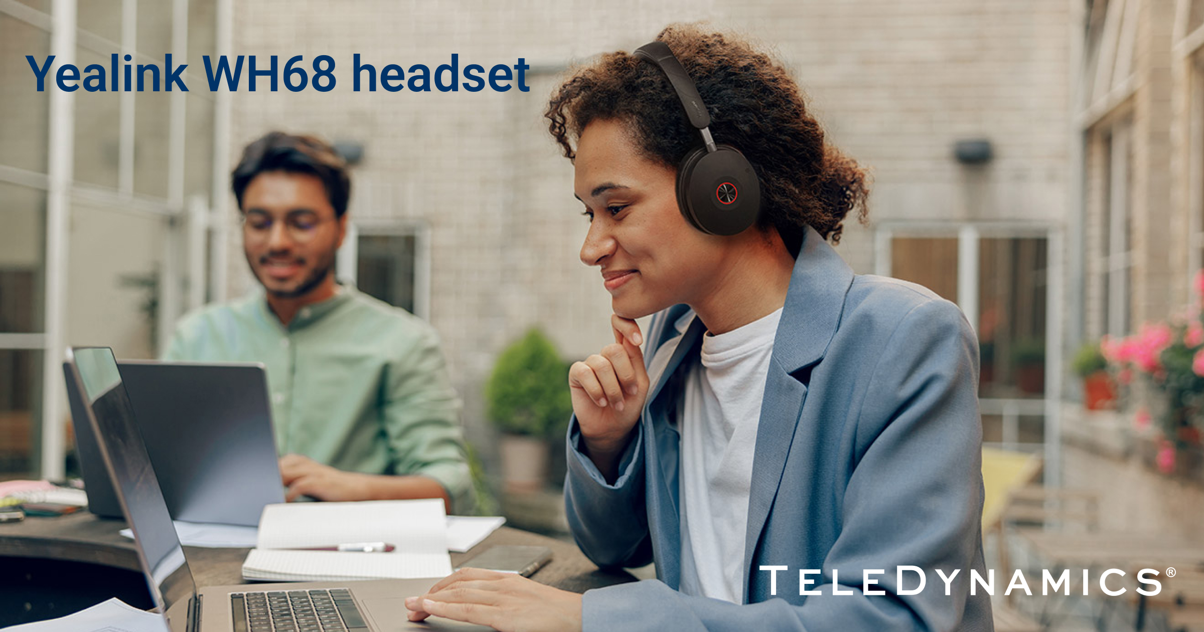 Woman using a Yealink WH68 wireless headset at her desk - TeleDynamics blog