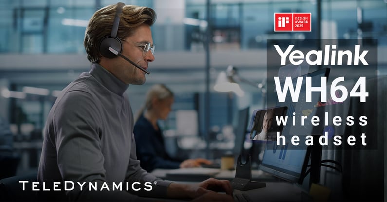 Worker at his desk wearing a Yealink WH64 wireless headset -- distributed by TeleDynamics