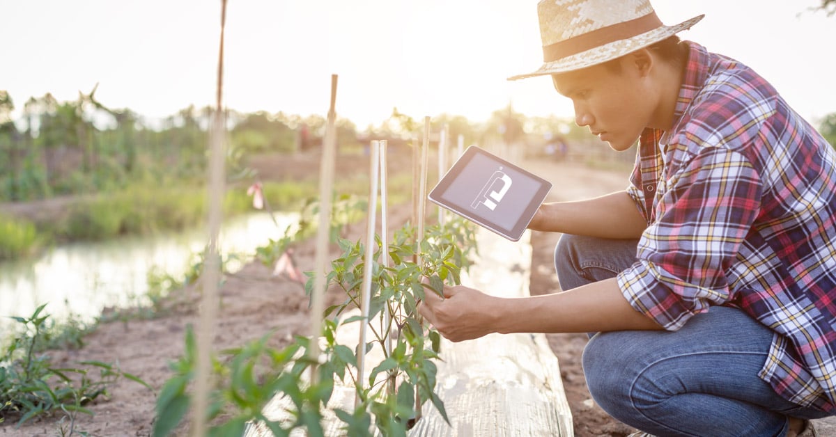 farmer with a connected tablet computer with TeleDynamics logo