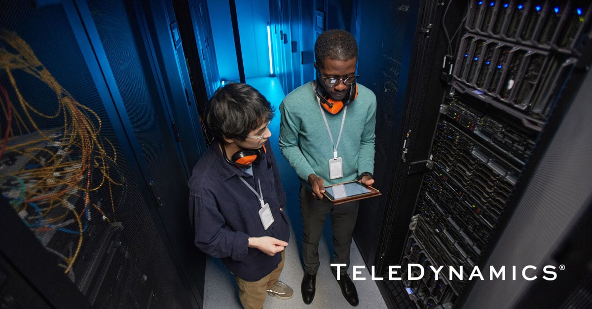 Two data engineers in a modern data center - TeleDynamics blog