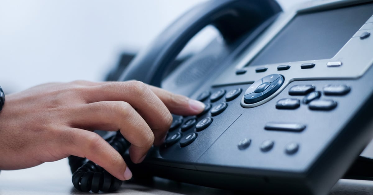 close-up of a hand dialing a phone