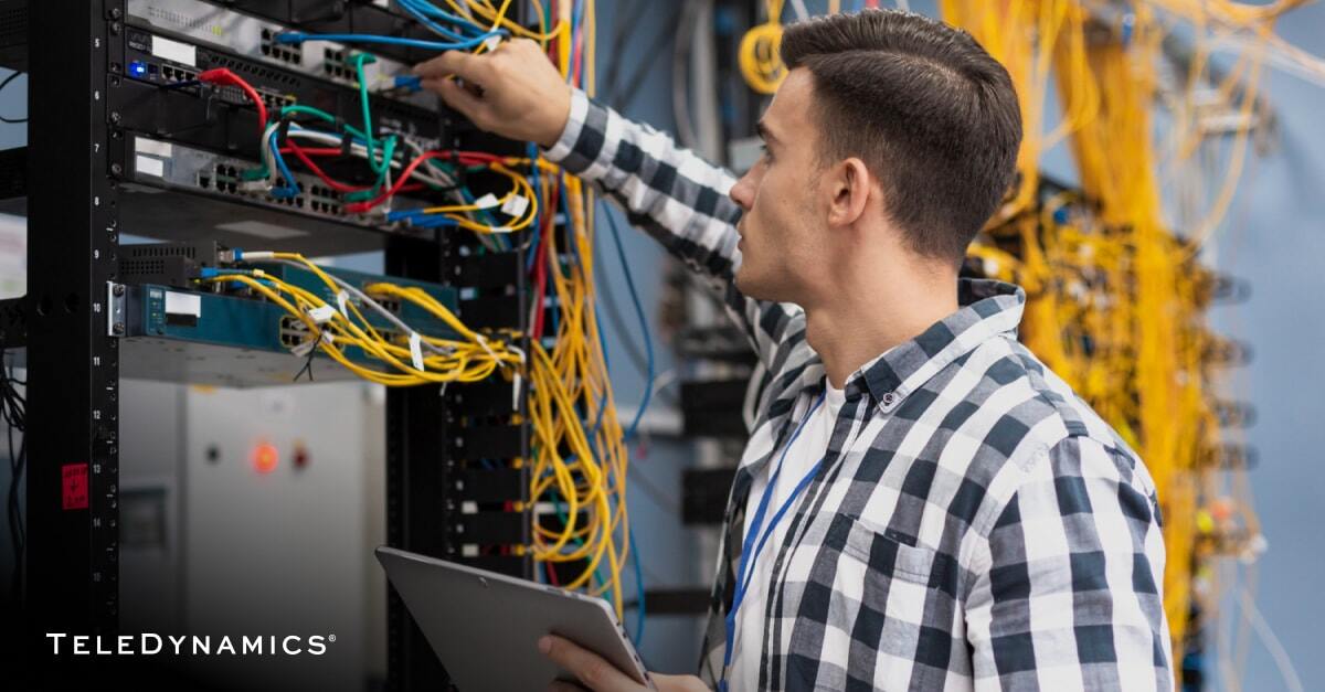 Network engineer in a server room - TeleDynamics blog