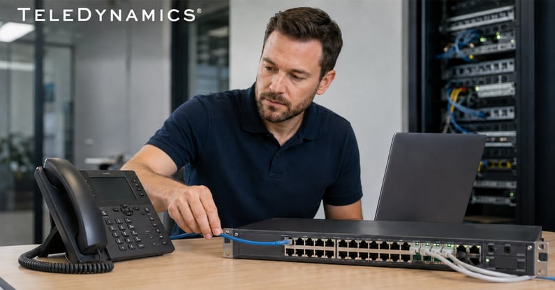 IT engineer provisioning an IP phone - TeleDynamics blog
