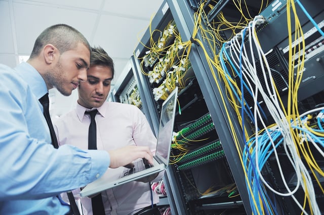 businessmen in a network server room