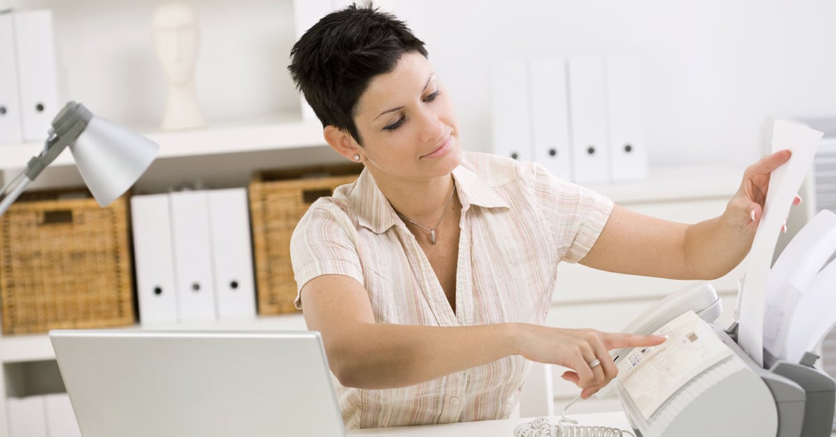 woman at a fax machine