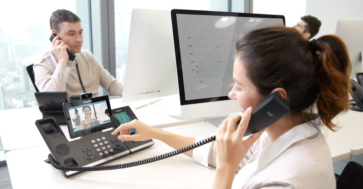 executive using the Yealink VP59 smart IP video phone at the office
