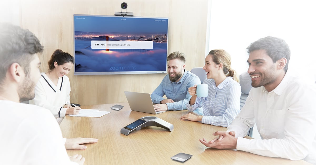 People in a meeting room using Yealink's CP960-UVC Zoom Rooms Kit