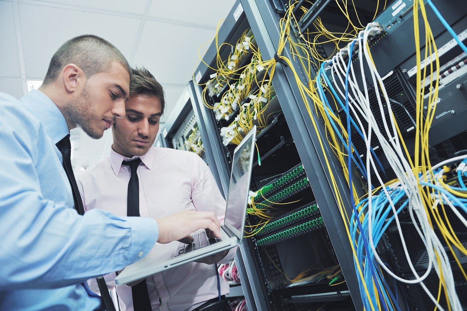 businessmen in a network server room